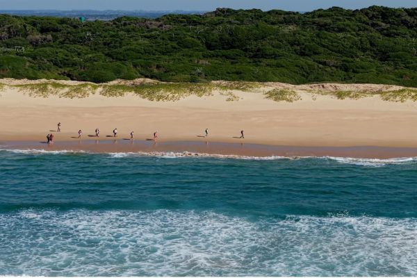 Hiking group walking along the beach at Kosi Bay