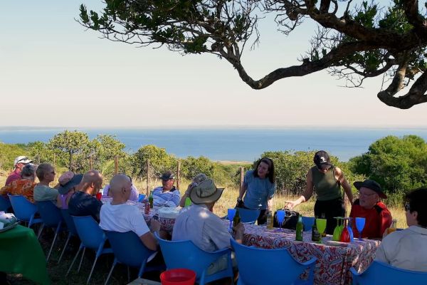 Hikers enjoying an outdoor lunch overlooking the ocean at Kosi Bay